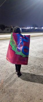 Rear view of woman walking on beach