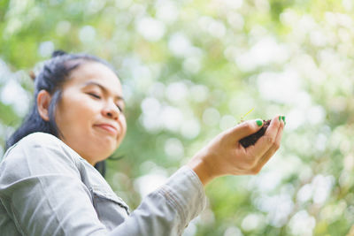 Young woman using mobile phone outdoors