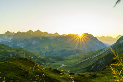 Scenic view of mountains against clear sky during sunset