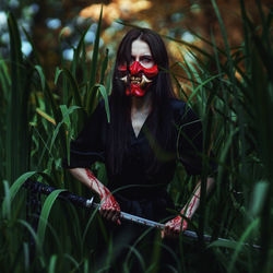 Portrait of woman with red leaves