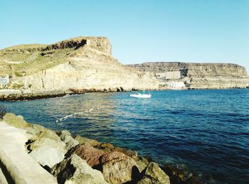 Scenic view of sea against clear blue sky