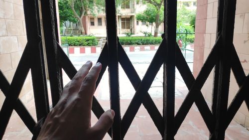 Close-up of hand on glass window
