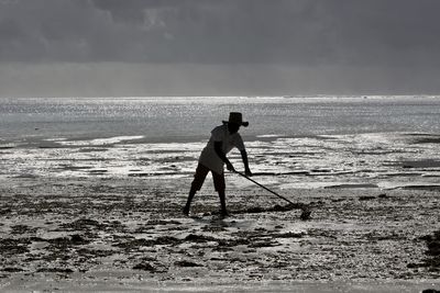 Full length of man on beach against sky