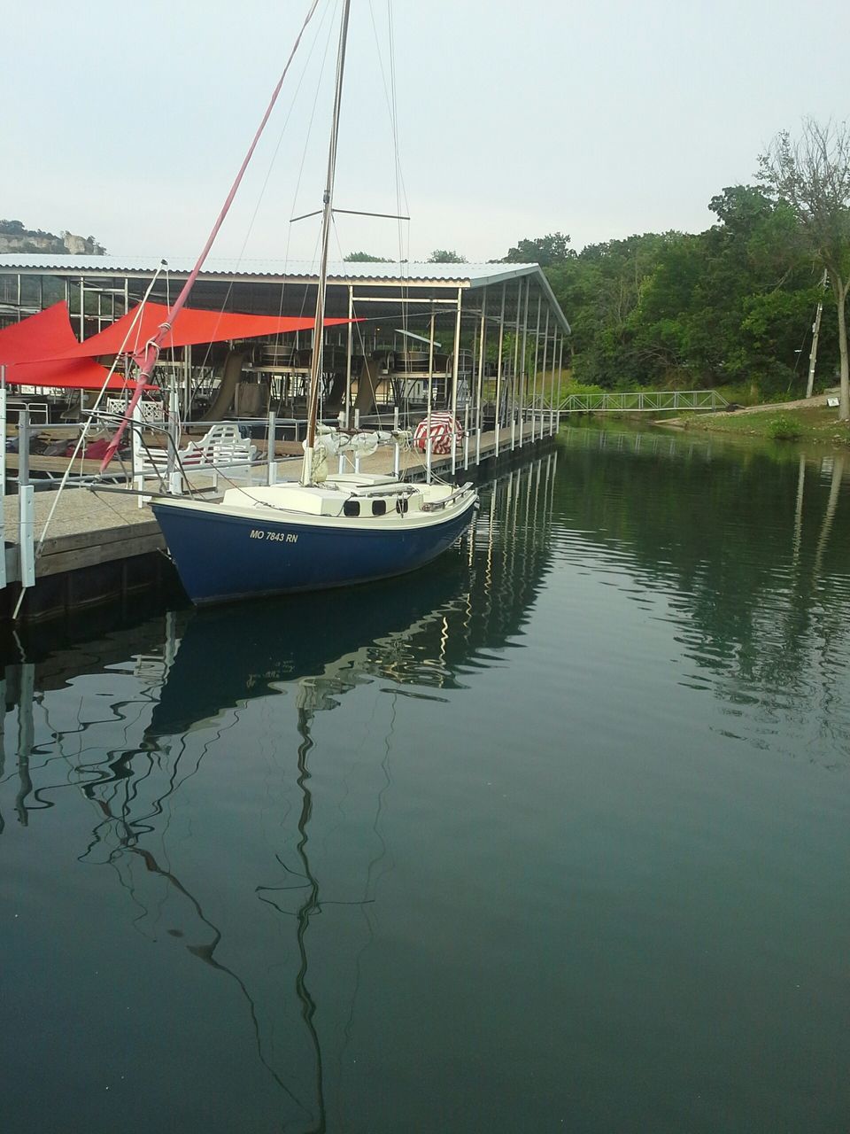 nautical vessel, transportation, boat, water, moored, mode of transport, reflection, waterfront, lake, mast, tree, sailboat, nature, tranquility, sky, travel, river, day, outdoors, clear sky