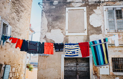 Low angle view of clothes drying against buildings