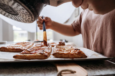 Side view of midsection of women making pastry