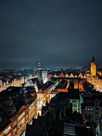 High angle view of illuminated buildings against sky at night