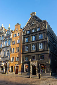 Low angle view of residential building against blue sky