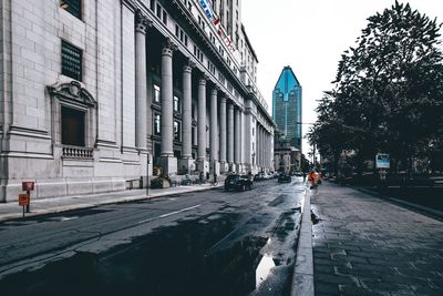 City street amidst buildings during rainy season