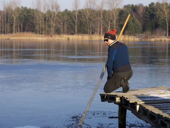 Full length of man standing by lake