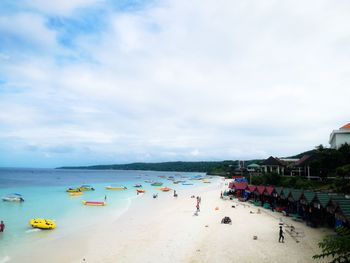 People on beach against sky