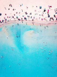 High angle view of people swimming in sea