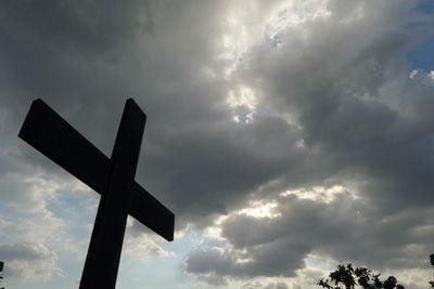 Low angle view of cross sign against sky