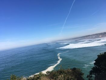 Scenic view of sea against blue sky