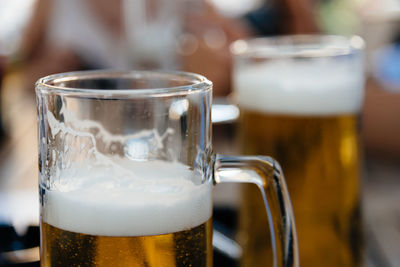 Close-up of beer glasses in bar