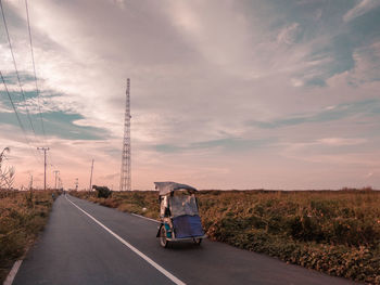 Man on road against sky