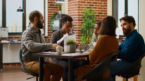 Side view of business colleagues working at office