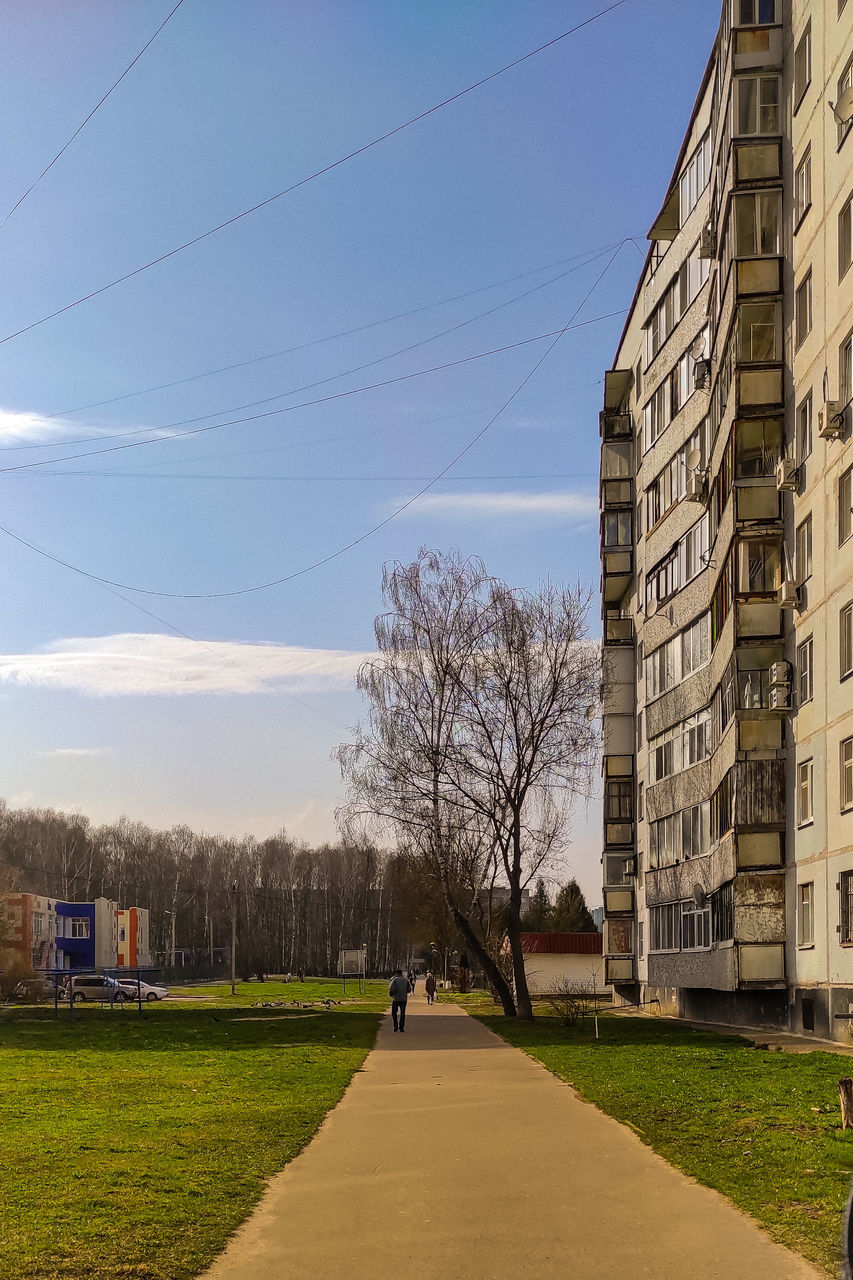 ROAD BY BUILDINGS AGAINST SKY