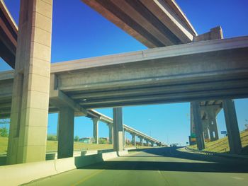 Low angle view of bridge against blue sky