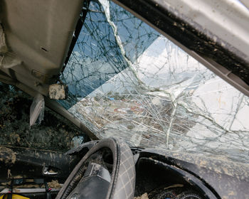 Broken glass window of abandoned car