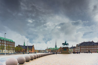 Buildings against cloudy sky