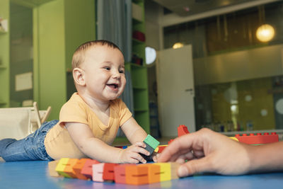 Happy boy playing with toy at home