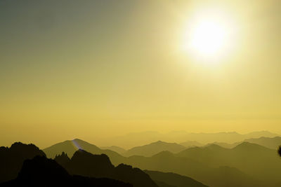 Scenic view of silhouette mountains against sky during sunset