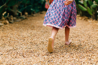 Low section of girl standing outdoors