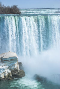 Scenic view of waterfall against sea