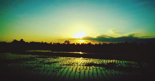 Scenic view of sunset over lake