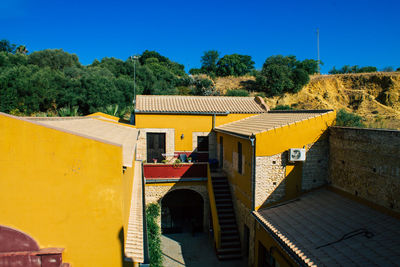 View of buildings against clear blue sky