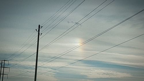 Low angle view of electricity pylon against sky