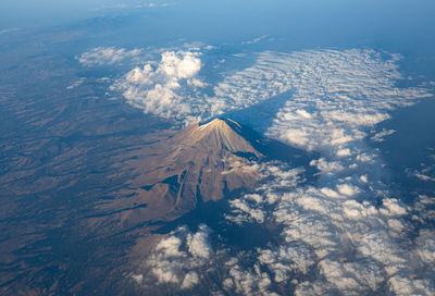 Aerial view of snowcapped mountains against sky