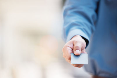 Midsection of man using mobile phone