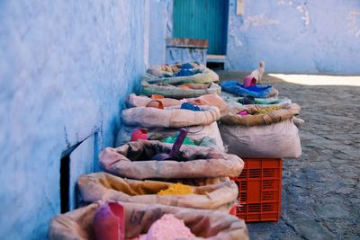 Various vegetables for sale on table against wall