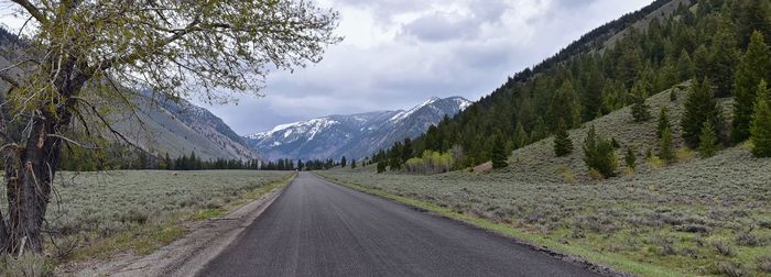 Empty road along countryside landscape