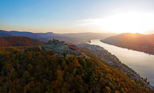 Scenic view of mountains and buildings against sky