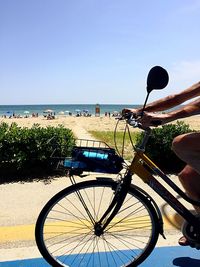 Bicycle by sea against clear sky