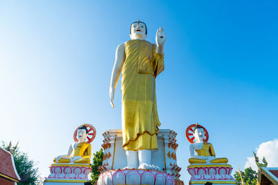 Low angle view of statue against blue sky