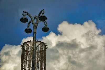 Low angle view of cross on building against sky