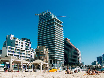 Buildings against clear blue sky in city