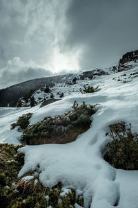 Scenic view of snow covered mountains against sky