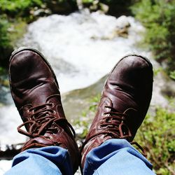 Low section of man wearing shoes standing outdoors