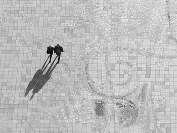 High angle view of people walking on swimming pool