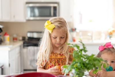 Cute kids preparing food on table at home