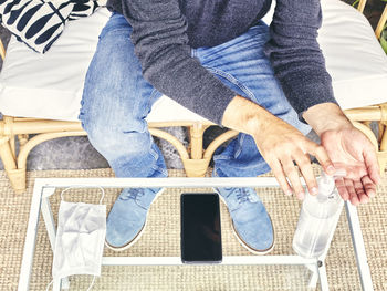 Low section of man sitting on sofa