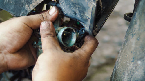 Close-up of man working on metal