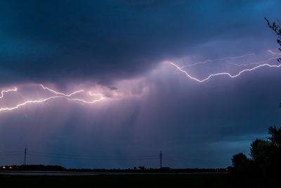 Low angle view of lightning against sky at night