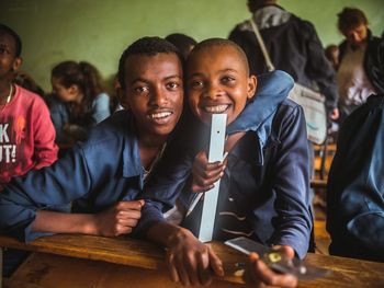 Portrait of happy friends in classroom