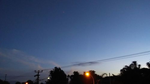 Low angle view of silhouette trees against sky